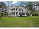 Two-story house with wrap around porch, mature landscaping and large yard at 320 29Th Nw St, Bradenton, FL 34205