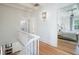 Upstairs hallway with white walls and hardwood floors at 320 29Th Nw St, Bradenton, FL 34205