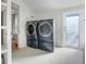 Laundry room with modern washer and dryer and exterior access at 320 29Th Nw St, Bradenton, FL 34205