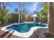 Irregular shaped pool with spa, brick patio, and lush landscaping at 320 29Th Nw St, Bradenton, FL 34205