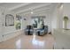 Bright sitting room with comfy armchairs, natural light, and terrazzo floors at 320 29Th Nw St, Bradenton, FL 34205