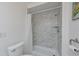 Shower and toilet in second bathroom with marble-look tile at 4531 13Th E St, Ellenton, FL 34222