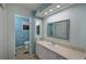 Bathroom with a vanity, large mirror, and separate toilet area at 4531 13Th E St, Ellenton, FL 34222