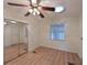 Bedroom with mirrored closet doors and wood-look flooring at 4531 13Th E St, Ellenton, FL 34222