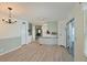 Open dining area with wood-look flooring and chandelier at 4531 13Th E St, Ellenton, FL 34222
