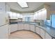 U-shaped kitchen with white cabinets and light countertops at 4531 13Th E St, Ellenton, FL 34222