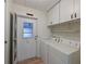 Laundry room with washer, dryer, and storage cabinets at 4531 13Th E St, Ellenton, FL 34222