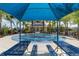 Splash pad with picnic tables under a shaded area near a community building at 4651 Claremont Park Dr, Bradenton, FL 34211