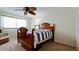 Bedroom with a wooden bed frame and ceiling fan at 4726 Independence Dr # 4726, Bradenton, FL 34210