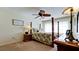 Spacious bedroom with a wooden post bed and ceiling fan at 4726 Independence Dr # 4726, Bradenton, FL 34210