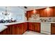 Well-equipped kitchen boasts wood cabinets and granite countertops at 4726 Independence Dr # 4726, Bradenton, FL 34210