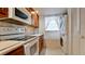 Kitchen with white appliances, wood cabinets, and tile backsplash at 4726 Independence Dr # 4726, Bradenton, FL 34210