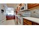 Modern kitchen with white appliances and wood cabinetry at 4726 Independence Dr # 4726, Bradenton, FL 34210
