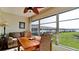 Bright sunroom with table and chairs, offering a view of the community at 4726 Independence Dr # 4726, Bradenton, FL 34210