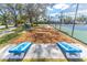 Cornhole and tennis courts with wood chip ground cover at 521 Bahia Beach Blvd, Ruskin, FL 33570