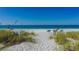 Relaxing beach with lounge chairs and clear water at 5311 Gulf Of Mexico Dr # 3, Longboat Key, FL 34228