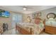 Primary bedroom with king-size bed and private access to balcony at 5311 Gulf Of Mexico Dr # 3, Longboat Key, FL 34228