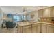 Open concept kitchen with granite island and ocean view at 5311 Gulf Of Mexico Dr # 3, Longboat Key, FL 34228