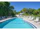 Resort-style pool with lounge chairs and lush landscaping at 5311 Gulf Of Mexico Dr # 3, Longboat Key, FL 34228