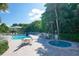 Community pool and spa with surrounding patio furniture at 5311 Gulf Of Mexico Dr # 3, Longboat Key, FL 34228