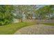 Landscaped backyard with paved patio and mature trees at 5401 Oak Grove Ct, Sarasota, FL 34233