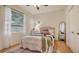 Cozy bedroom with a full-size bed and a window with sheer curtains at 5401 Oak Grove Ct, Sarasota, FL 34233
