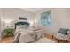 Bright bedroom with a green upholstered bed, window, and wood floors at 5401 Oak Grove Ct, Sarasota, FL 34233