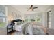 Spacious main bedroom with large windows, ceiling fan, and plush bedding at 5401 Oak Grove Ct, Sarasota, FL 34233