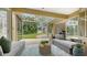 Cozy screened-in porch with wicker furniture and view of backyard at 5401 Oak Grove Ct, Sarasota, FL 34233