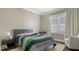 Bright bedroom with a full-size bed, and sitting chair at 5729 Hydrangea Cir, Sarasota, FL 34238