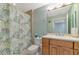Clean bathroom with shower and wood vanity at 615 Riviera Dunes Way # 104, Palmetto, FL 34221