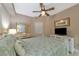 Bright bedroom with a king-size bed, dresser, and TV at 615 Riviera Dunes Way # 104, Palmetto, FL 34221