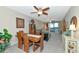 Charming dining area with wooden table and chairs, overlooking the living room at 615 Riviera Dunes Way # 104, Palmetto, FL 34221