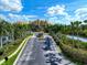 Gated entrance to community with palm trees and water views at 615 Riviera Dunes Way # 104, Palmetto, FL 34221