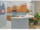 Modern kitchen with stainless steel appliances and light wood cabinets at 615 Riviera Dunes Way # 104, Palmetto, FL 34221
