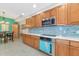 Modern kitchen with stainless steel appliances and light wood cabinets at 615 Riviera Dunes Way # 104, Palmetto, FL 34221