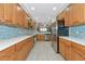 Modern kitchen with stainless steel appliances and light wood cabinets at 615 Riviera Dunes Way # 104, Palmetto, FL 34221