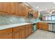Modern kitchen with stainless steel appliances and light wood cabinets at 615 Riviera Dunes Way # 104, Palmetto, FL 34221