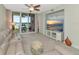 Bright living room with comfy seating, large TV, and access to a balcony at 615 Riviera Dunes Way # 104, Palmetto, FL 34221