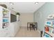 Home office with desk, chairs, and built-in shelving at 615 Riviera Dunes Way # 104, Palmetto, FL 34221