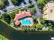 Resort-style pool with surrounding patio and landscaping at 615 Riviera Dunes Way # 104, Palmetto, FL 34221