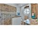 Spa-like bathroom with walk-in shower, granite vanity, and porthole window at 635 Key Royale Dr, Holmes Beach, FL 34217