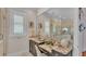 Vanity area in a spa-like bathroom with a large mirror and granite countertop at 635 Key Royale Dr, Holmes Beach, FL 34217