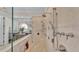 Walk-in shower with multiple shower heads and a built-in bench at 635 Key Royale Dr, Holmes Beach, FL 34217
