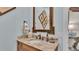 Vanity with granite countertop, decorative mirror, and light blue walls at 635 Key Royale Dr, Holmes Beach, FL 34217