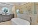 Bathroom with a freestanding tub and a large walk-in shower with multiple shower heads at 635 Key Royale Dr, Holmes Beach, FL 34217