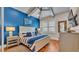 Spacious bedroom with blue and white bedding and hardwood floors at 635 Key Royale Dr, Holmes Beach, FL 34217