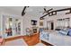Primary bedroom with fireplace, french doors to patio, and hardwood floors at 635 Key Royale Dr, Holmes Beach, FL 34217