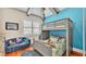 bedroom with a bunk bed, colorful bedding, and a cozy sitting area at 635 Key Royale Dr, Holmes Beach, FL 34217