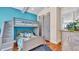 Charming bedroom with built-in bunk beds, gray accents, and hardwood floors at 635 Key Royale Dr, Holmes Beach, FL 34217